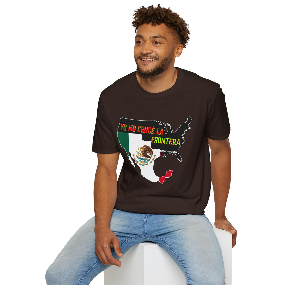 A man wearing a Dark Chocolate t-shirt with a graphic of the United States map filled with the Mexican flag and the Spanish text 'YO NO CRUCE LA FRONTERA'.